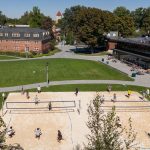 Students from the volleyball class play on the sand volleyball courts in Cleveland Commons courtyard.