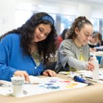 Candid shot of students painting.