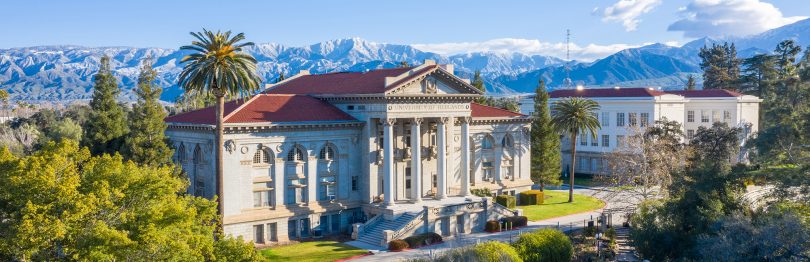 Administration Building on University of Redlands campus, with snowy mountains in the background